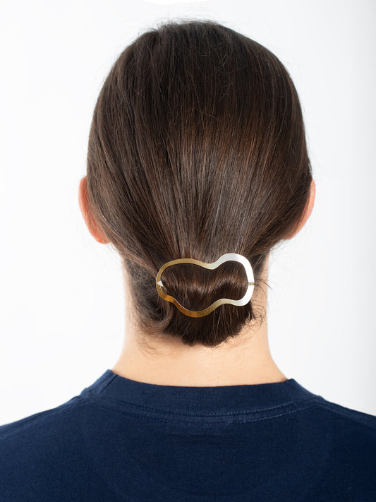 Low folded ponytail accented with designer hair clip Gae by Clinq x Oodd studios