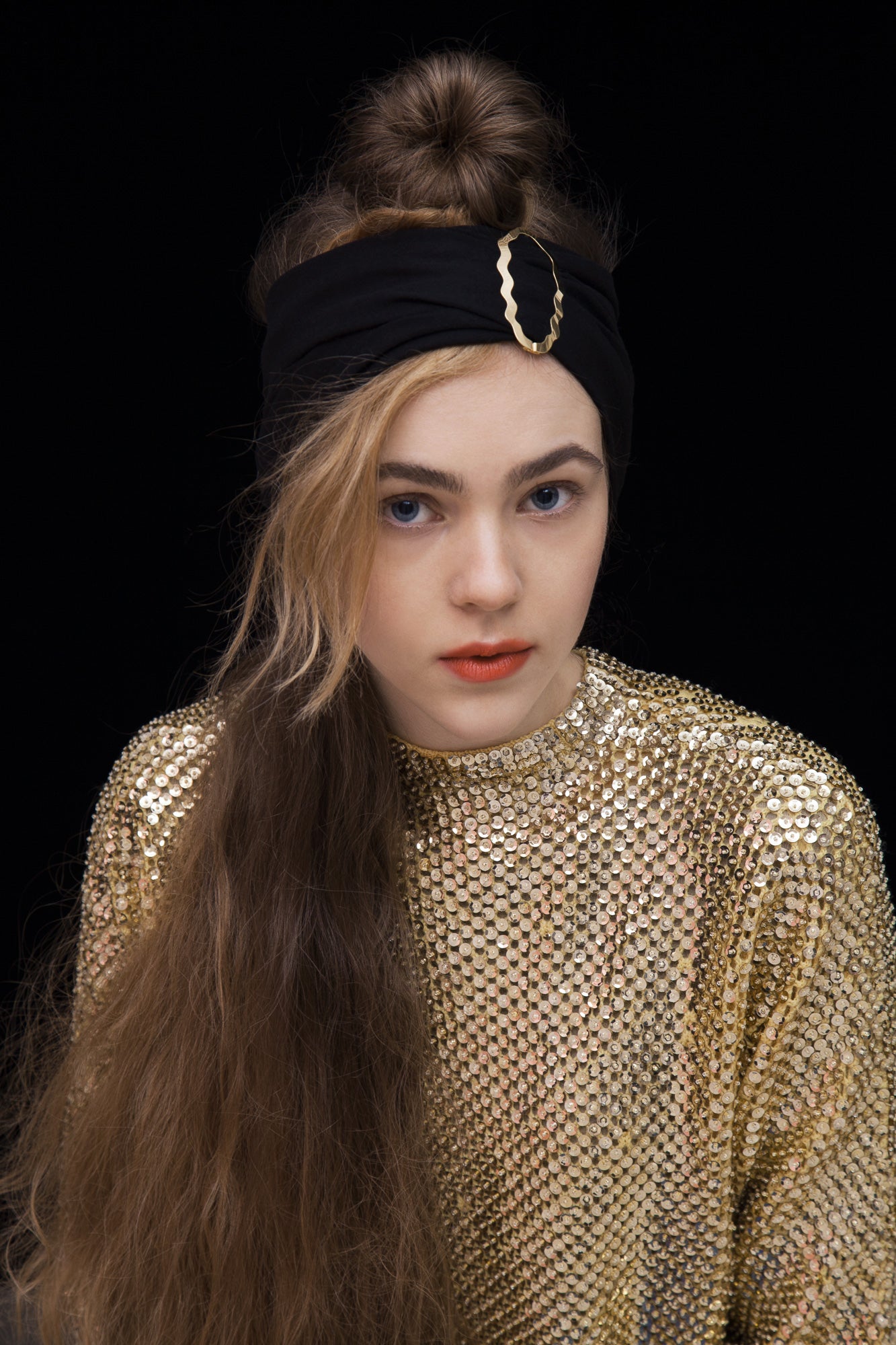 Front view of model wearing a headband accessorized with designer hair clip Helia by Clinq