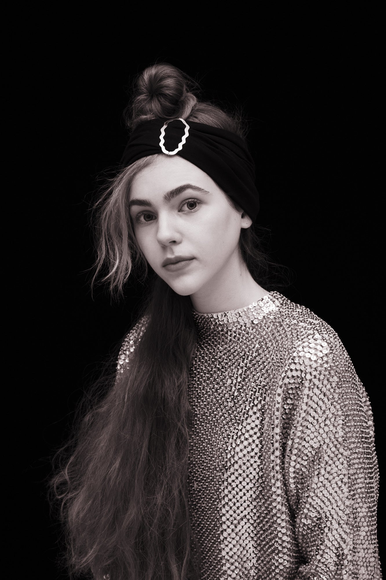 Portrait of model wearing a headband accessorized with designer hair clip Helia