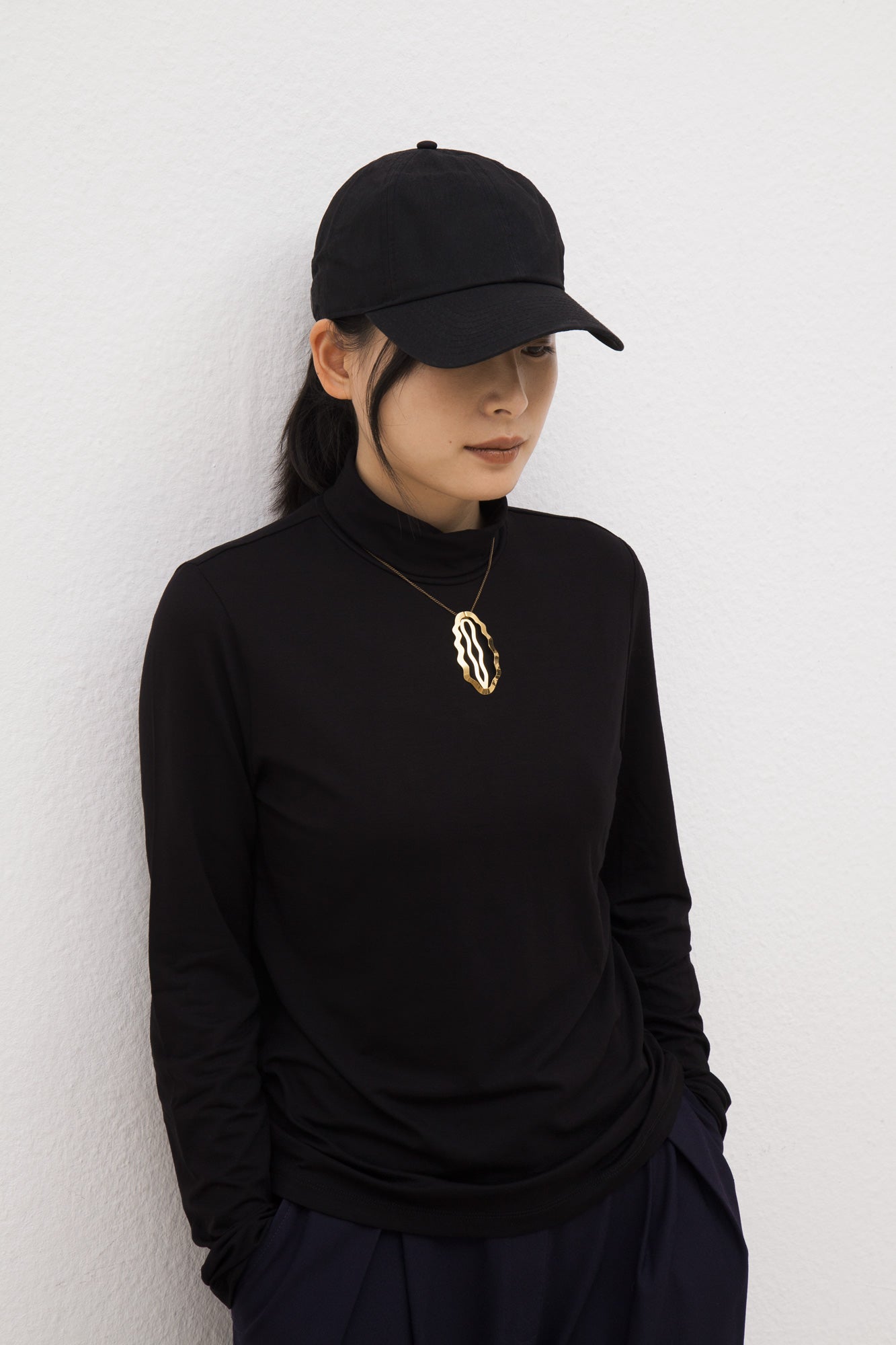 Front view of model wearing the designer hair clip Helia by Clinq as a necklace