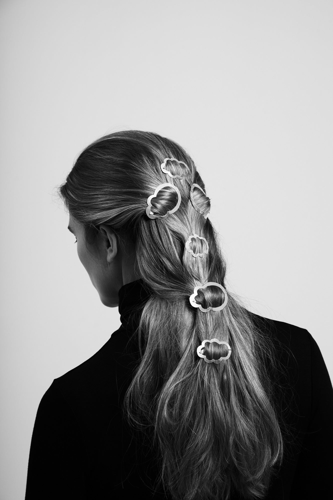 Side view of model wearing her hair in a half updo styled with designer hair clips Camille and Louise by Clinq