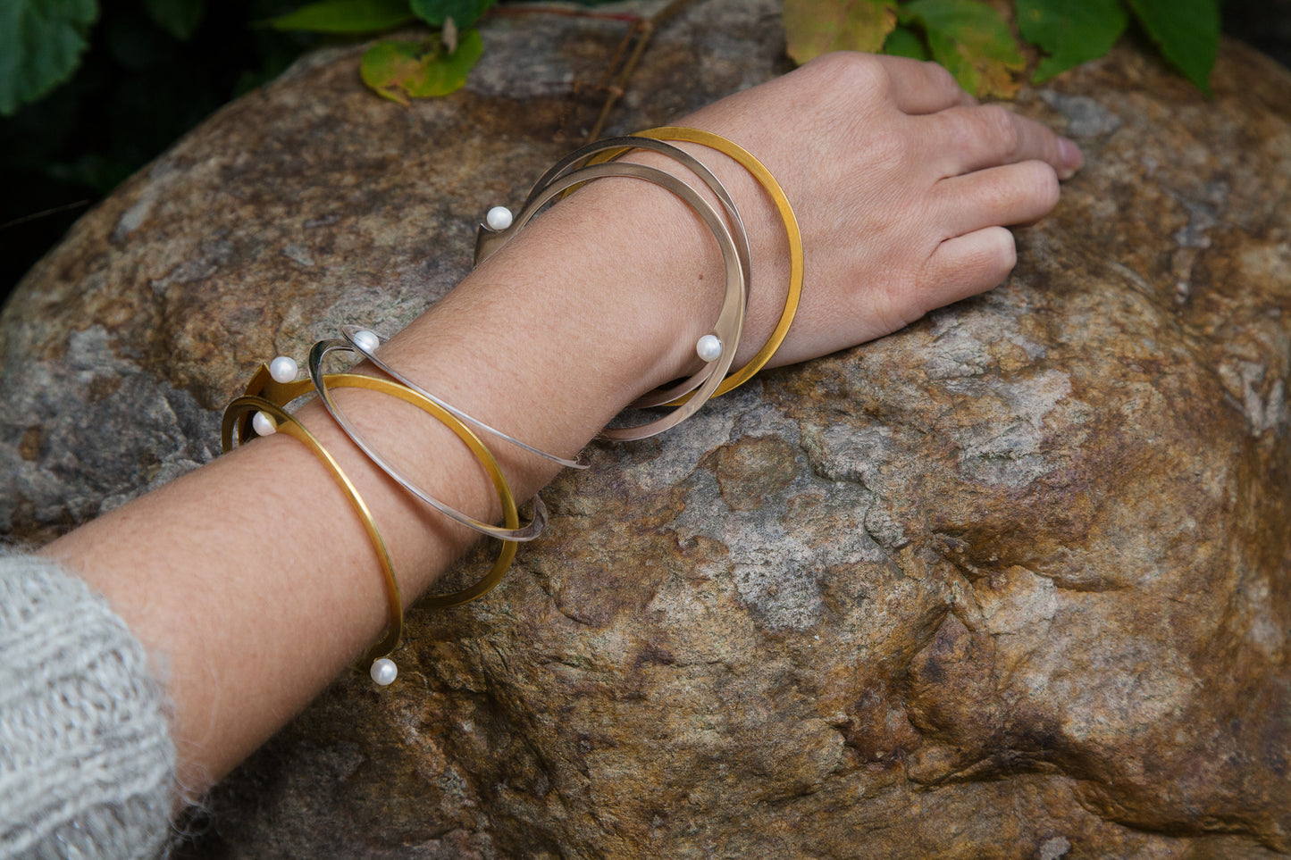 Model showing her stacked bangle bracelets ELEA by CLINQ