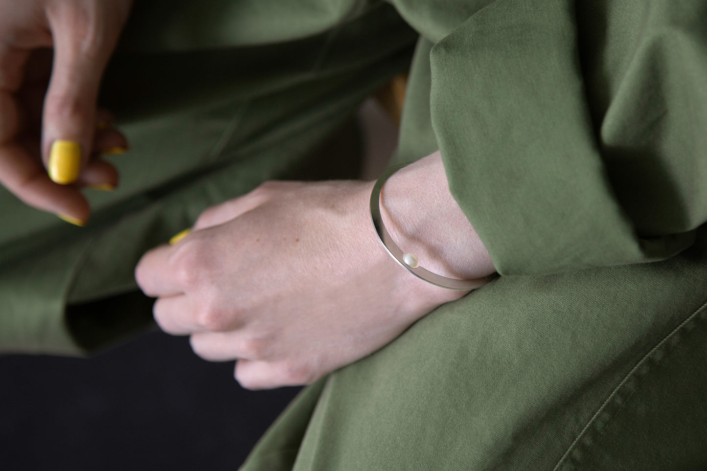Close up of a hand showing designer bangle Ivy by Clinq