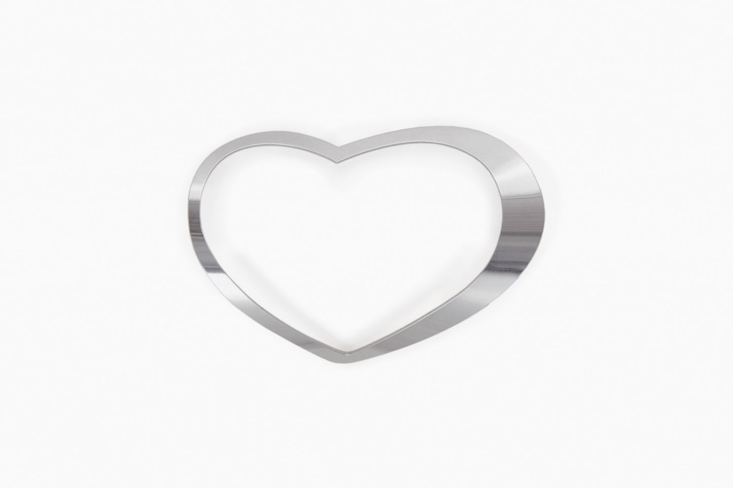 Product shot of silver-tone heart shaped bangle Zeta