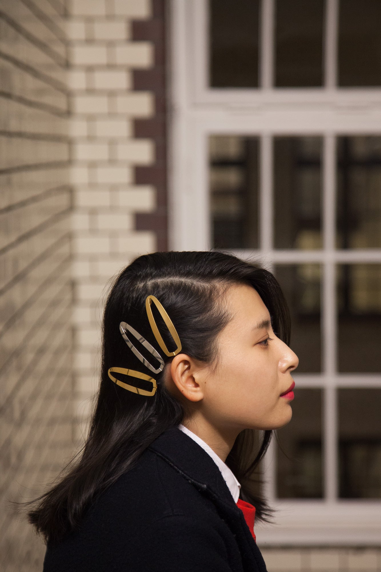 Side view of model wearing several hair clips of style Gaia by Clinq