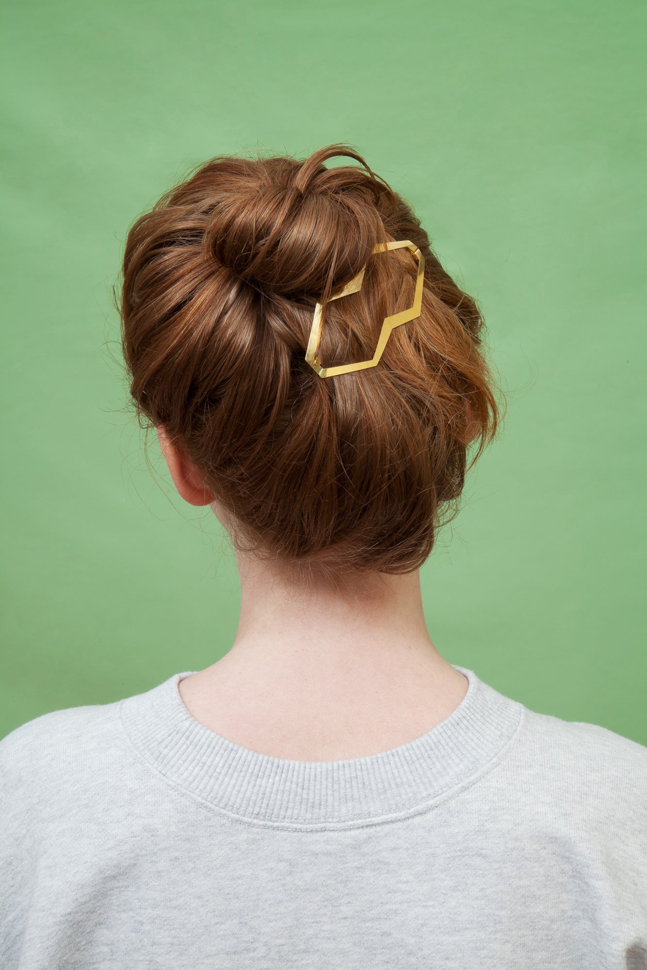 Back view of model wearing Top knot accented with Designer hair clip Hanya by Clinq