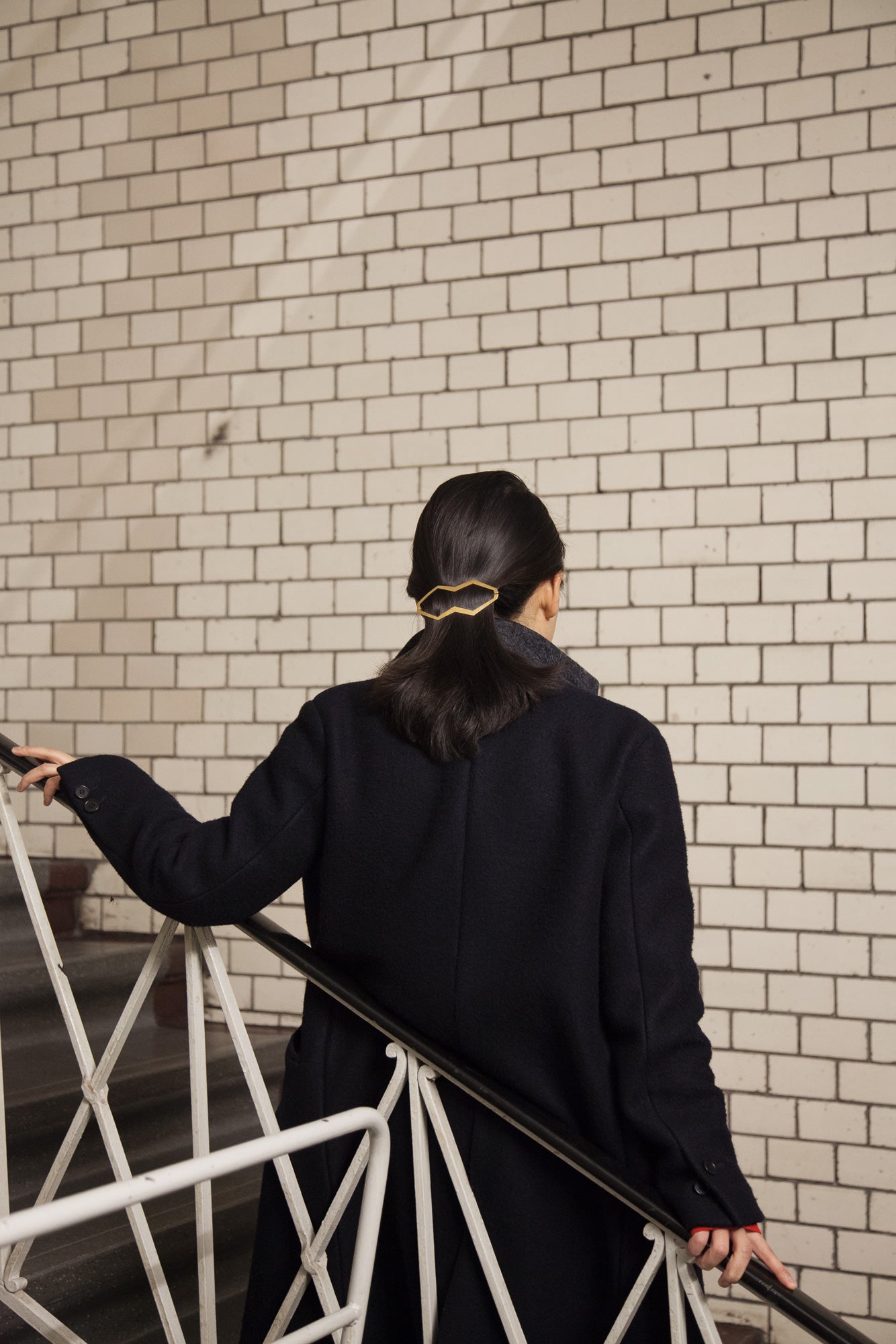 Back view of model wearing designer hair clip Hanya with a low ponytail