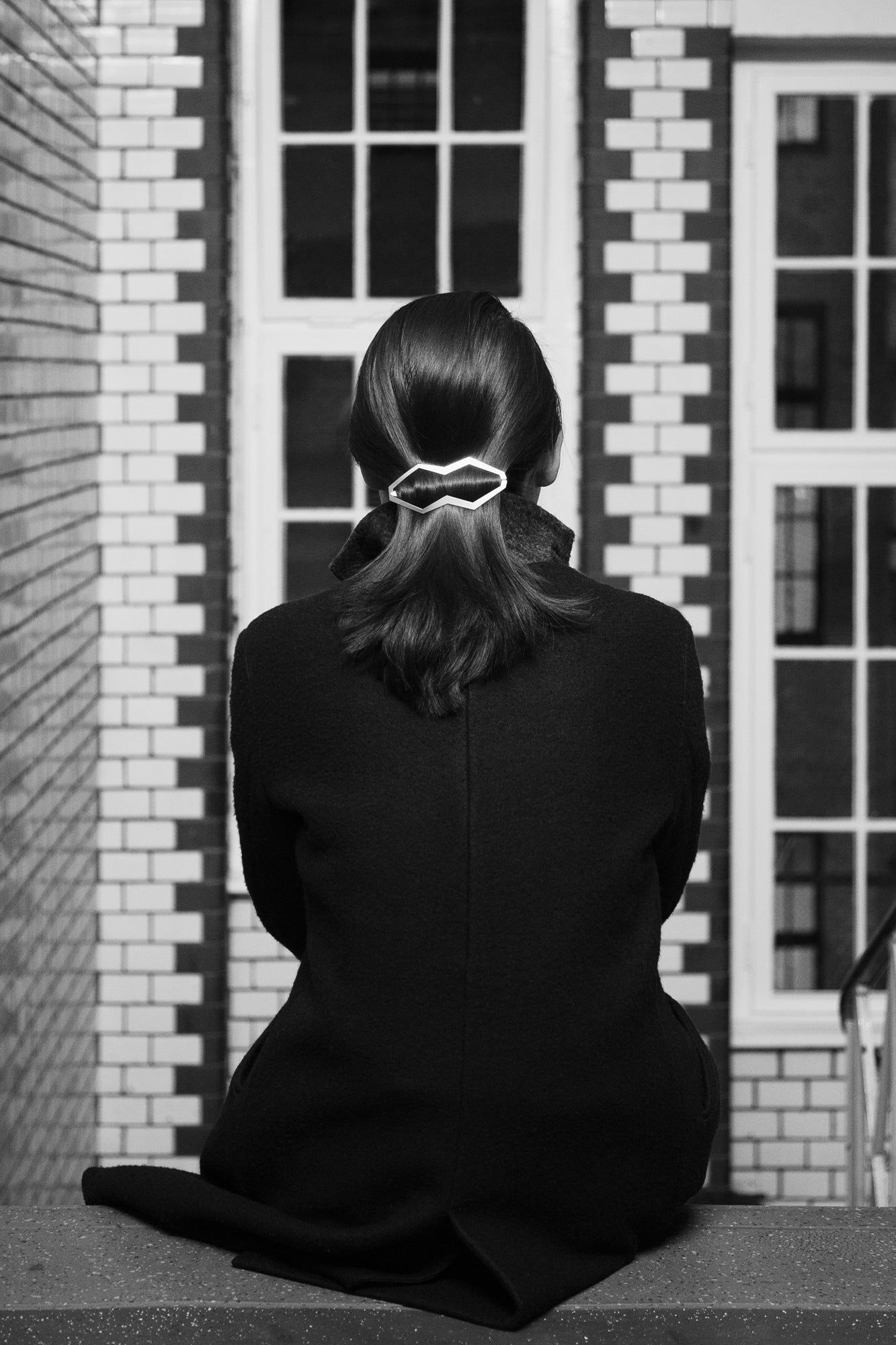 Back view of model wearing her hair in a low ponytail styled with designer hair clip Hanya