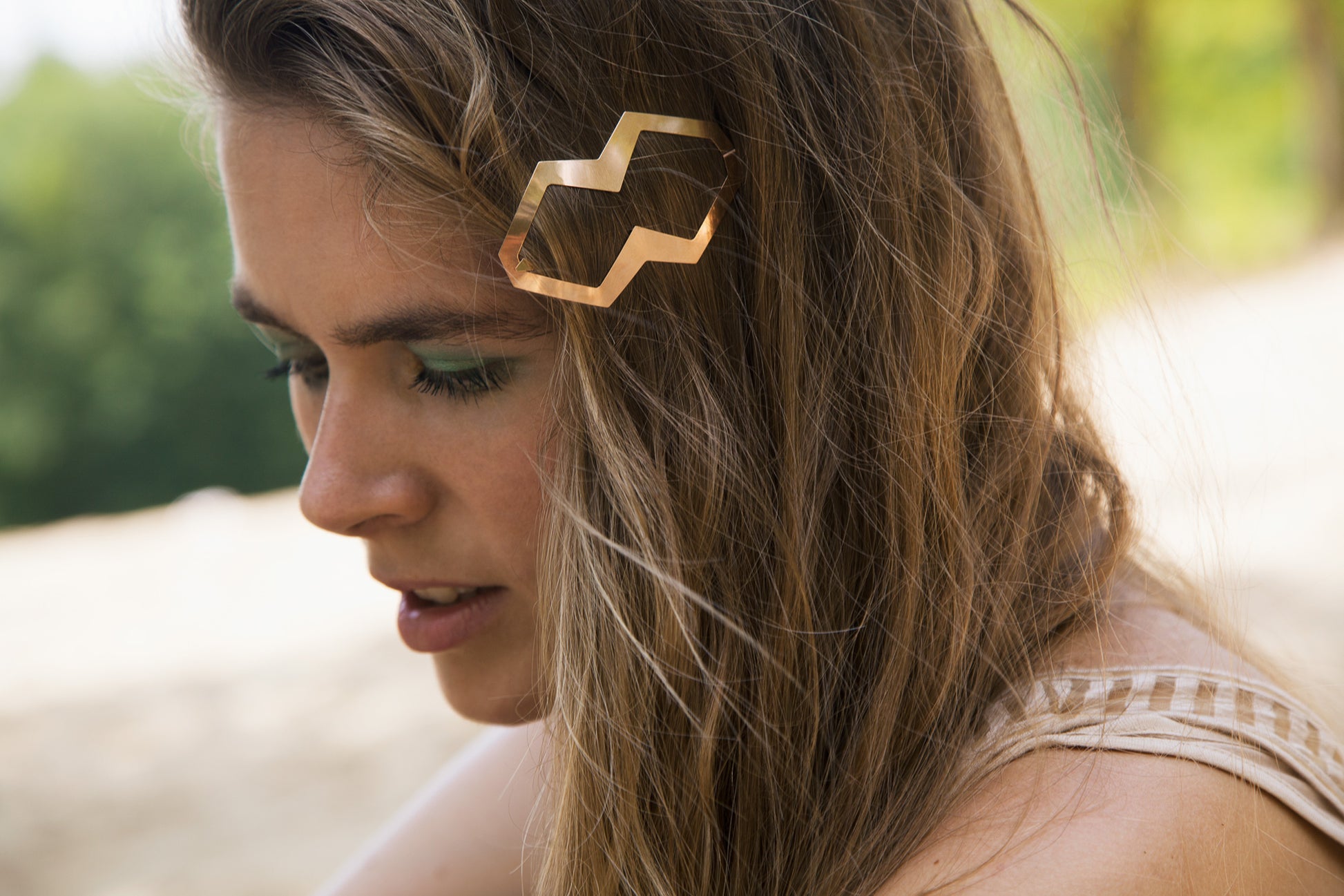 Side view of model wearing her hair down accessorized with designer hair clip Dora