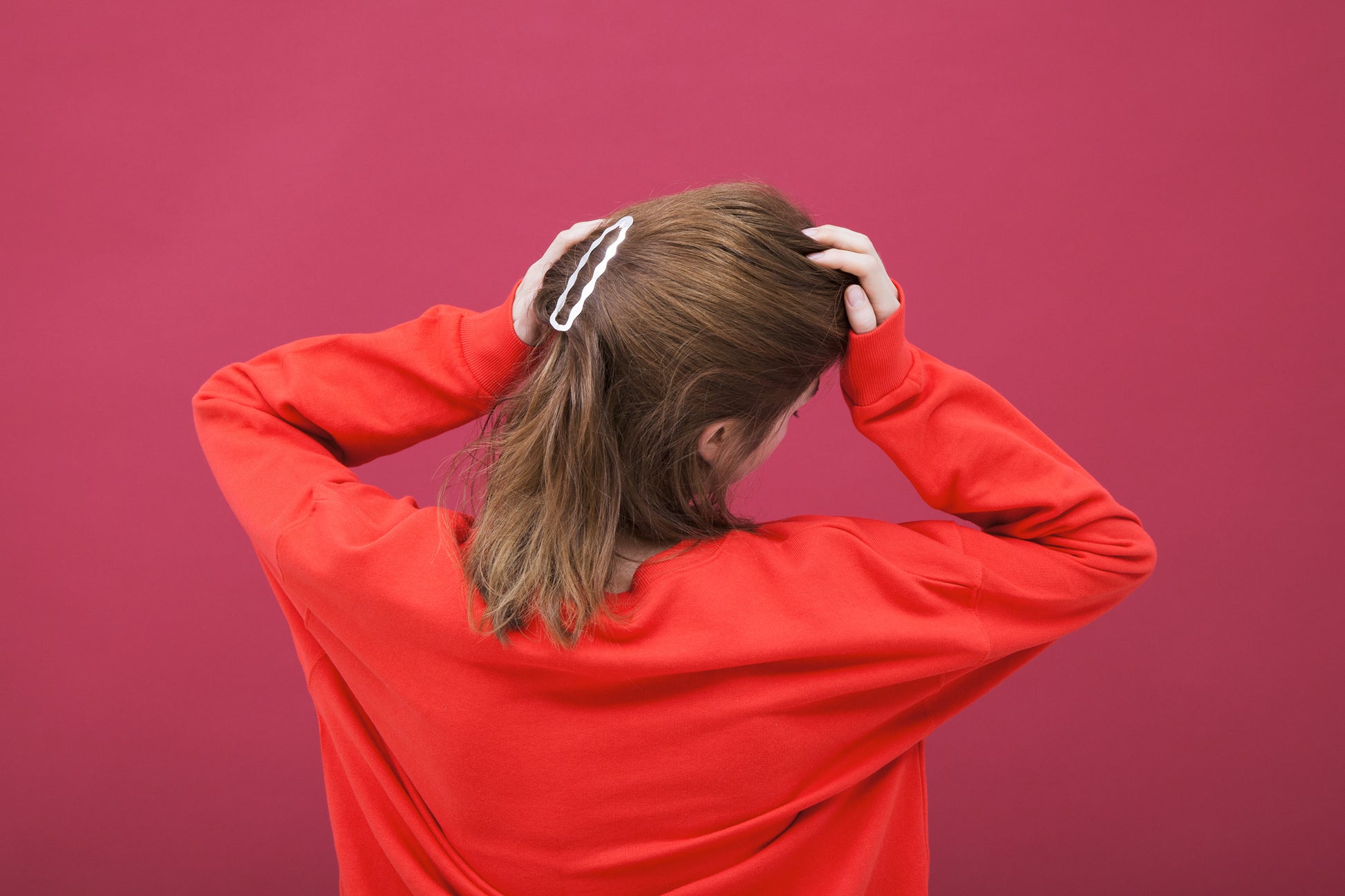 Side view of model wearing her hair accessorized with designer hair clip Frances