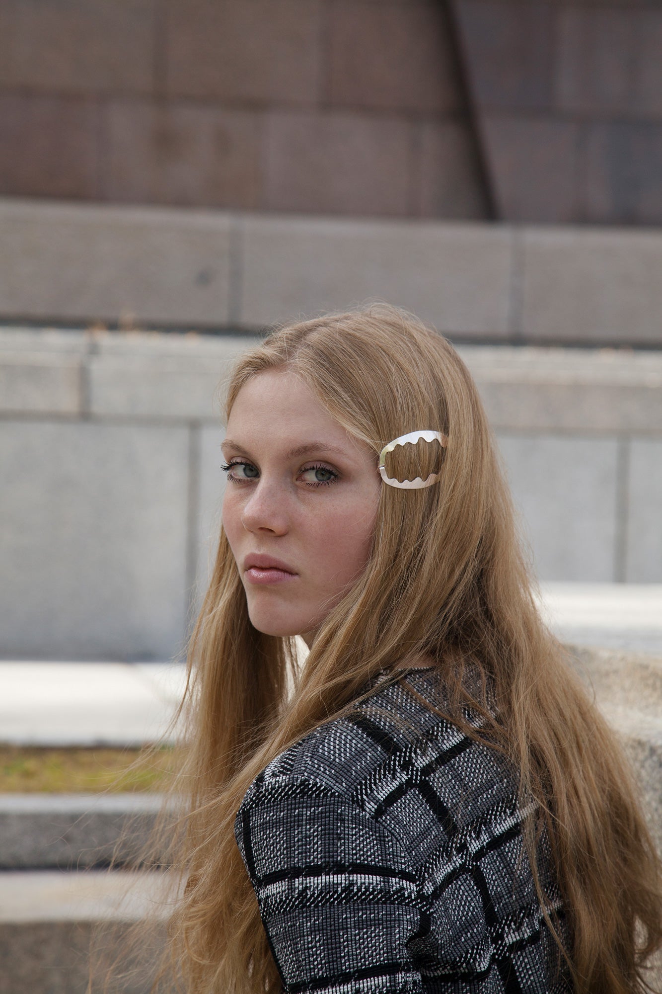 Model wearing her straight hair down accessorized with designer hair clip Ida on one side