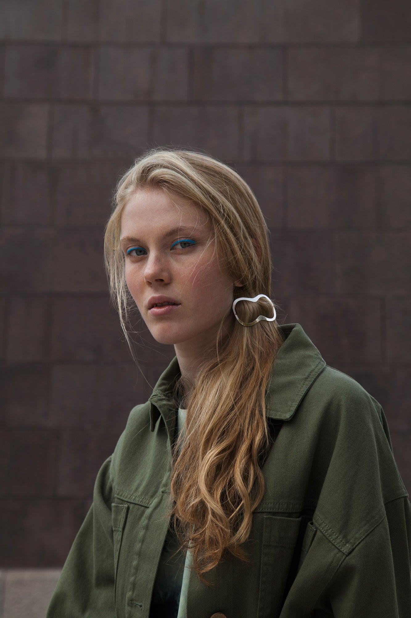 Front view of model wearing her hair in a messy low ponytail secured with designer barrette Elif by Clinq