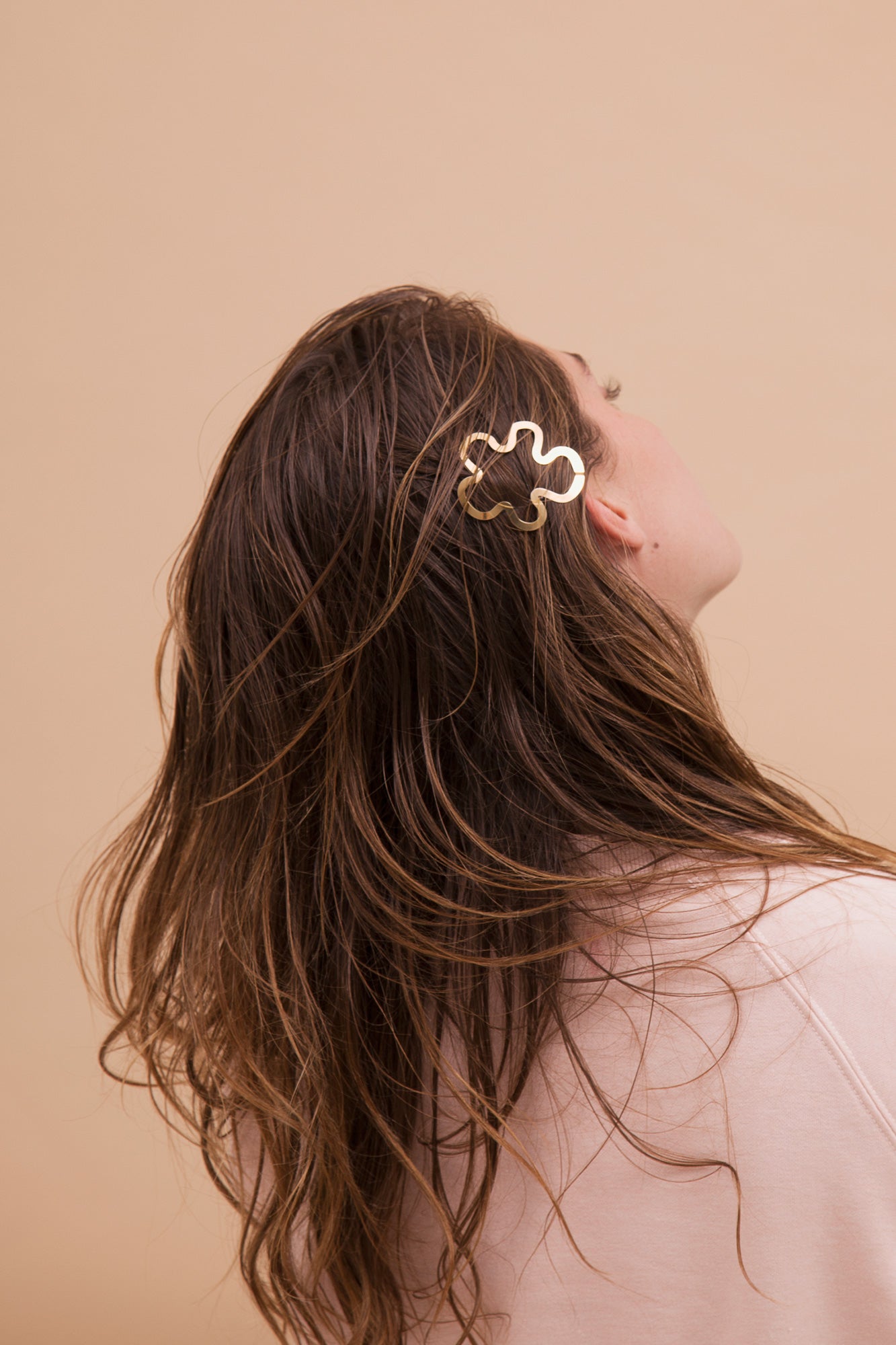 Model with her hair down styled with designer hair clip Hilma