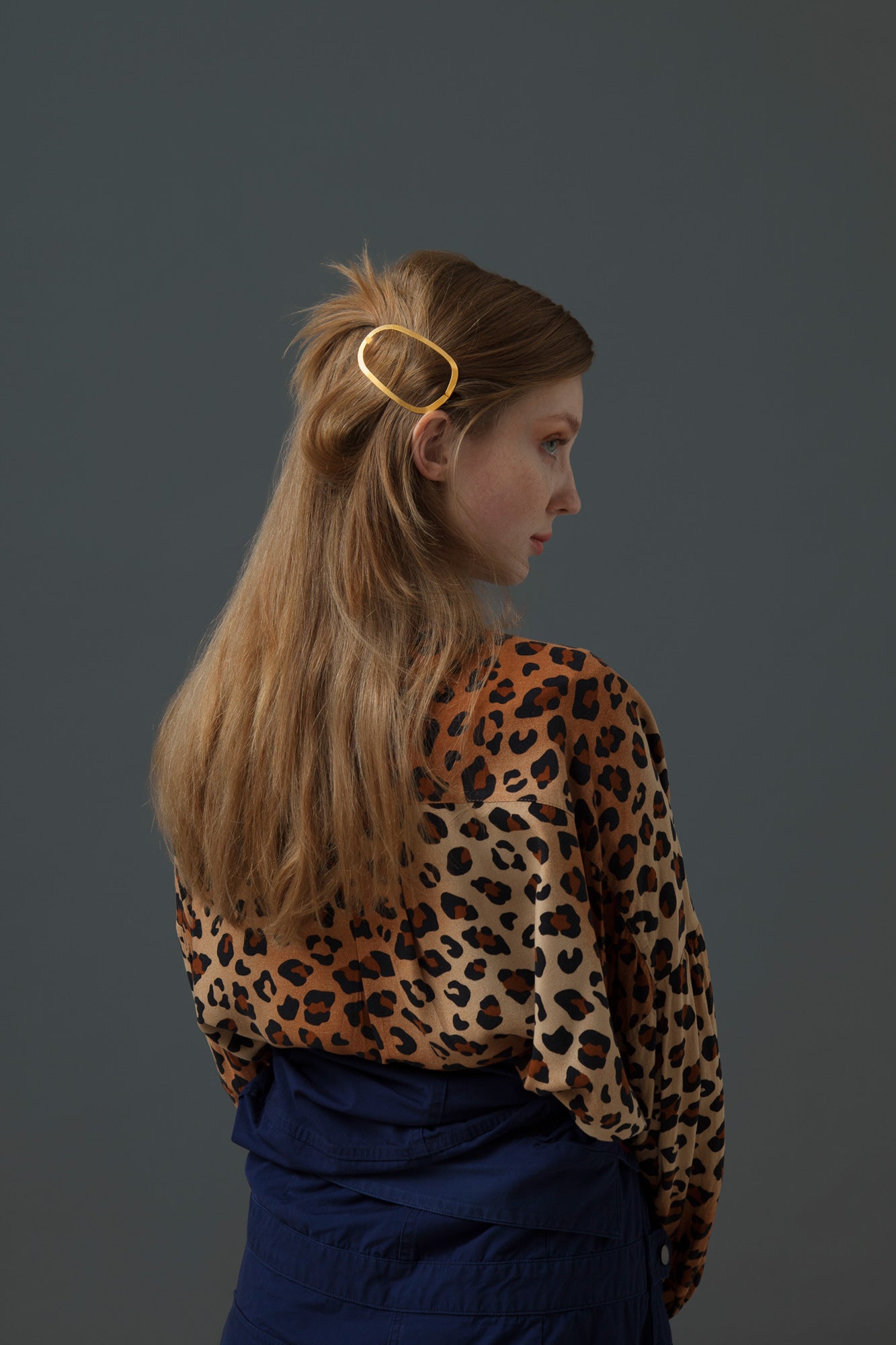 Model wearing her hair down with one strand folded up secured with designer hair clip Ginger by Clinq
