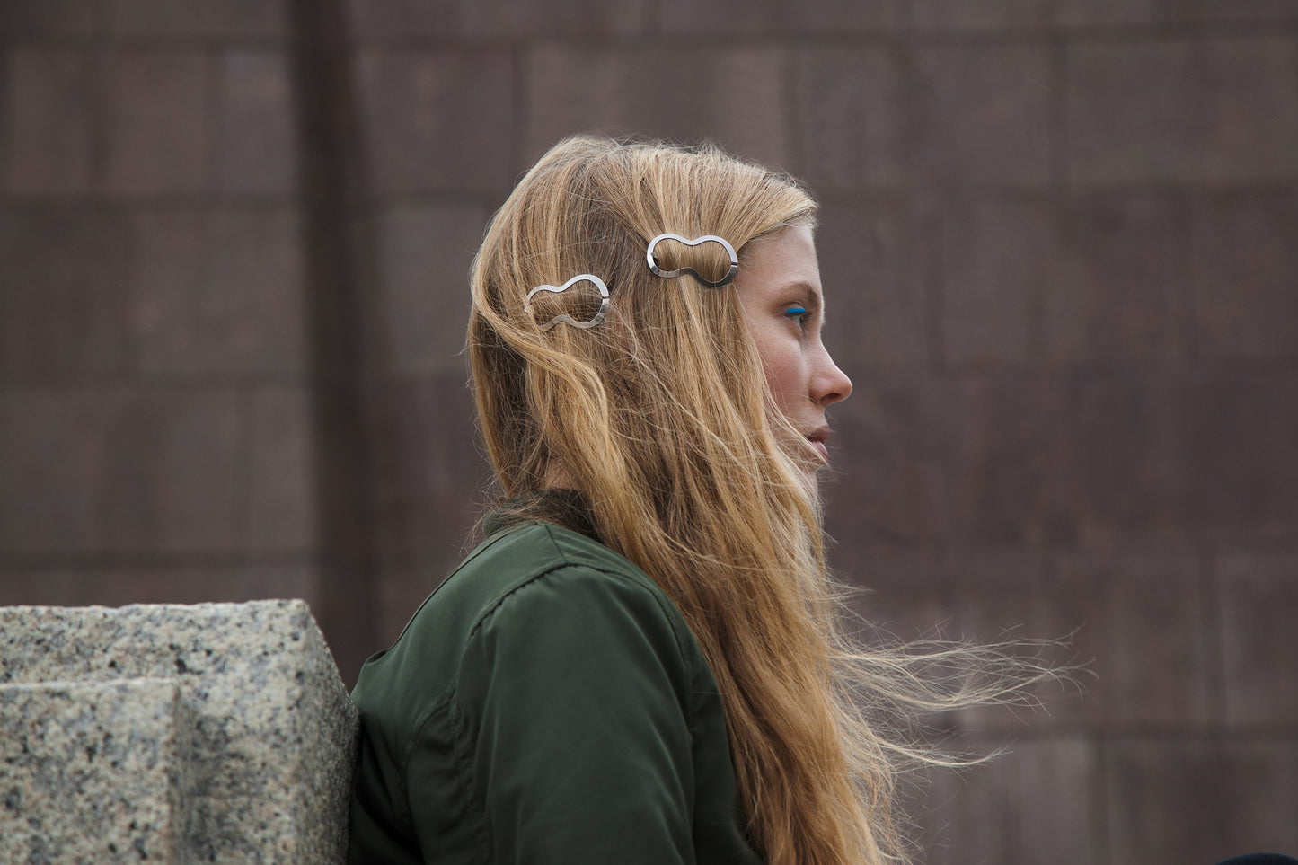 Side view of Model wearing her hair down accented with two designer hair clips BILLIE by CLINQ