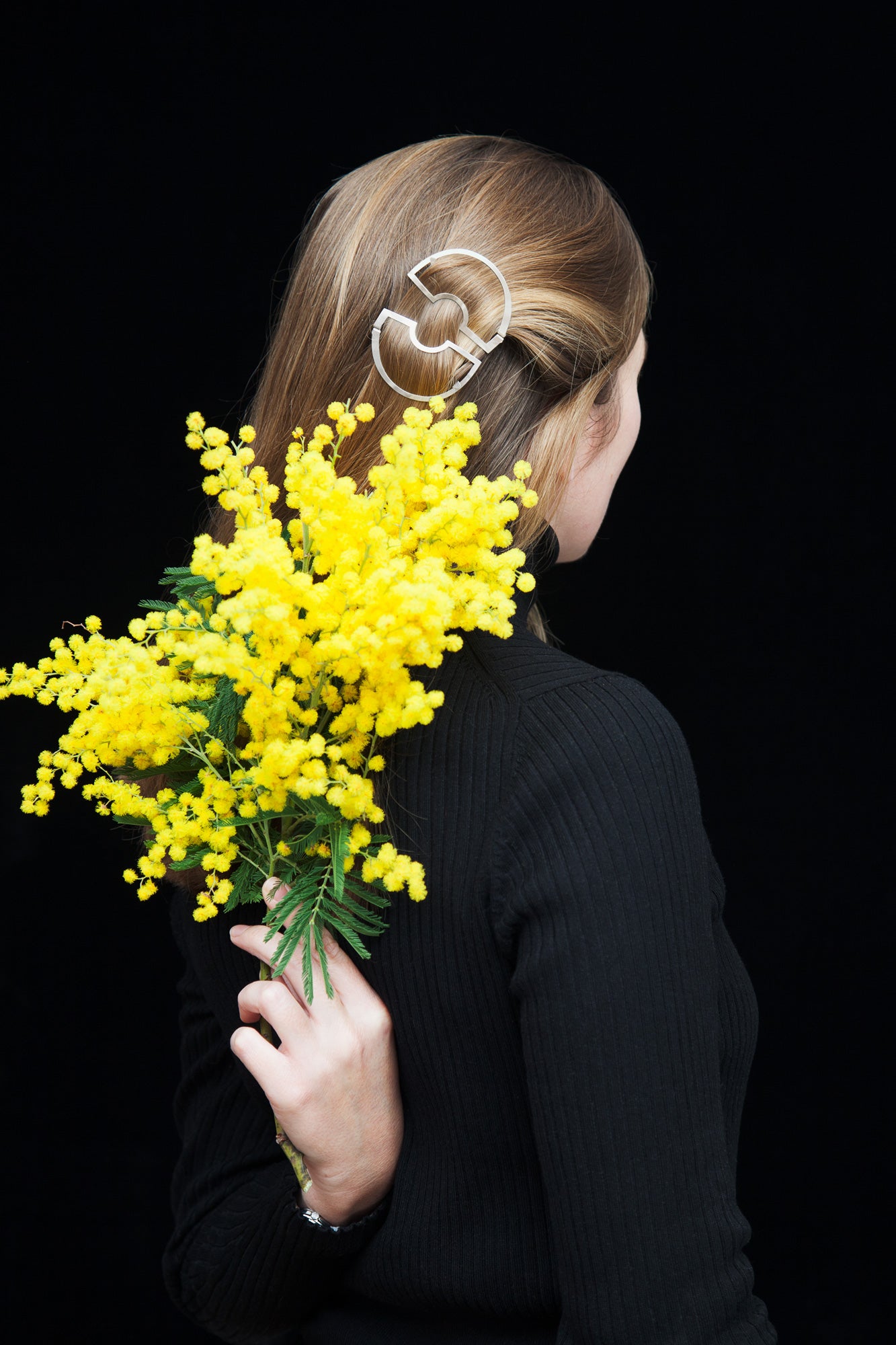 Back view of model wearing her hair down highlighted with designer hair clips Carlina by Clinq 