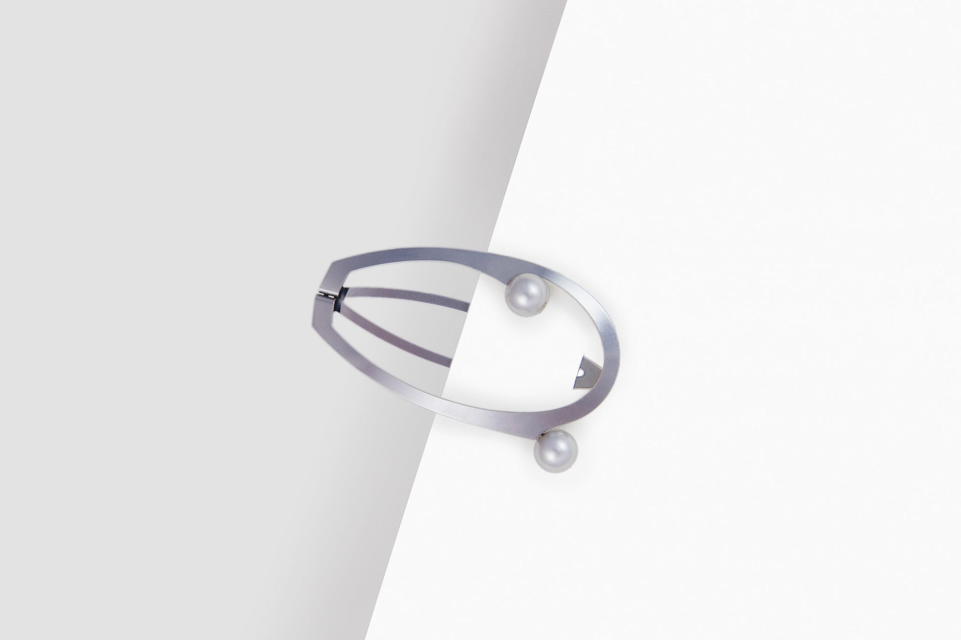 Designer hair clips made from stainless steel embellished with silver coloured shell pearls