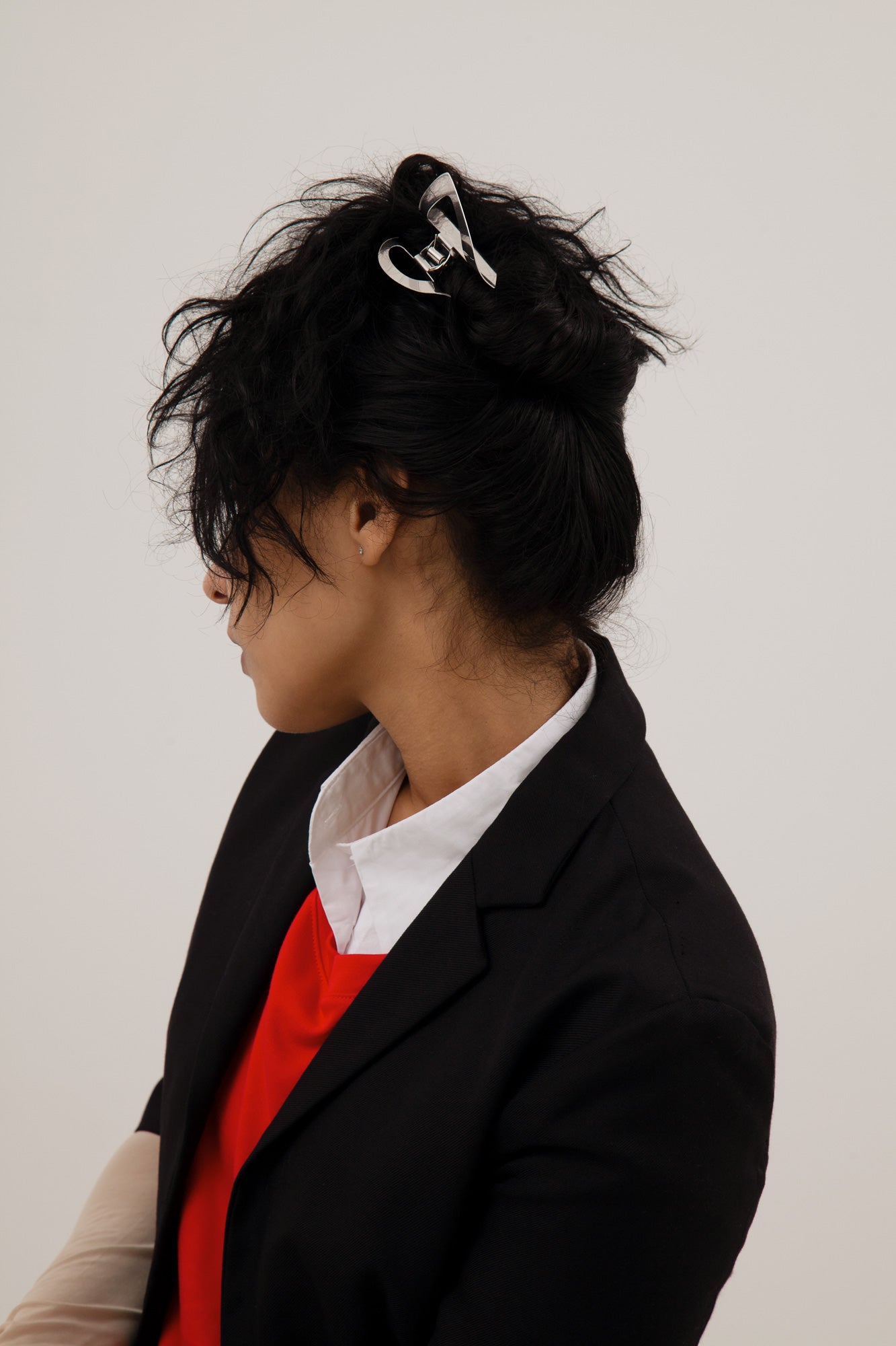 Model wearing her hair up with asymmetrical claw clip Pia made from mirror polished stainless steel 