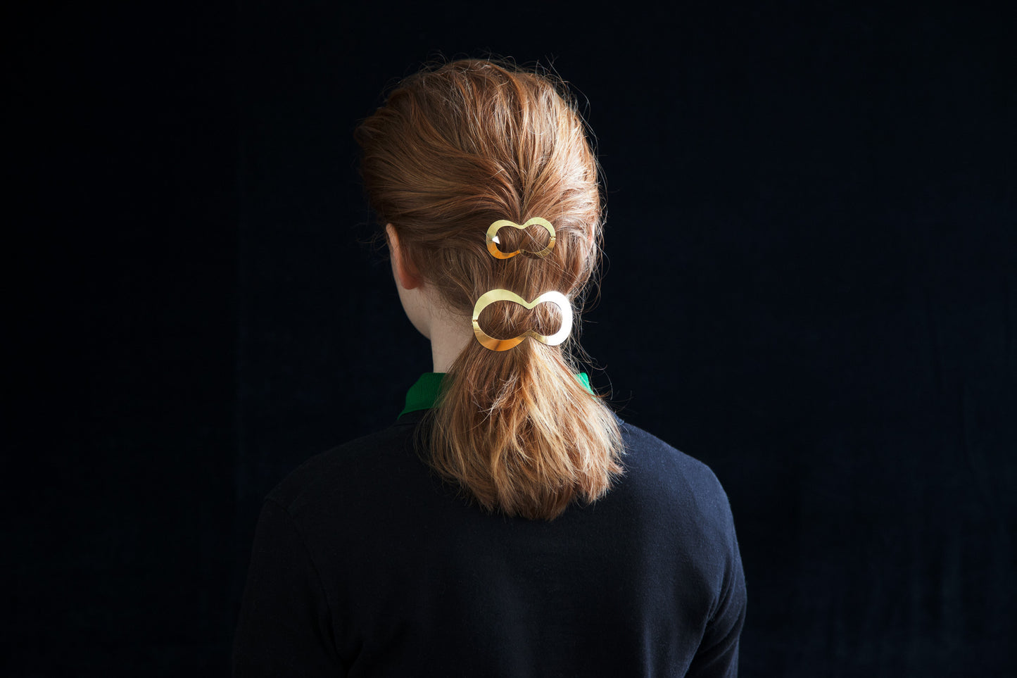 back view of a model with designer hair clips Lina and Clio accenting a low ponytail