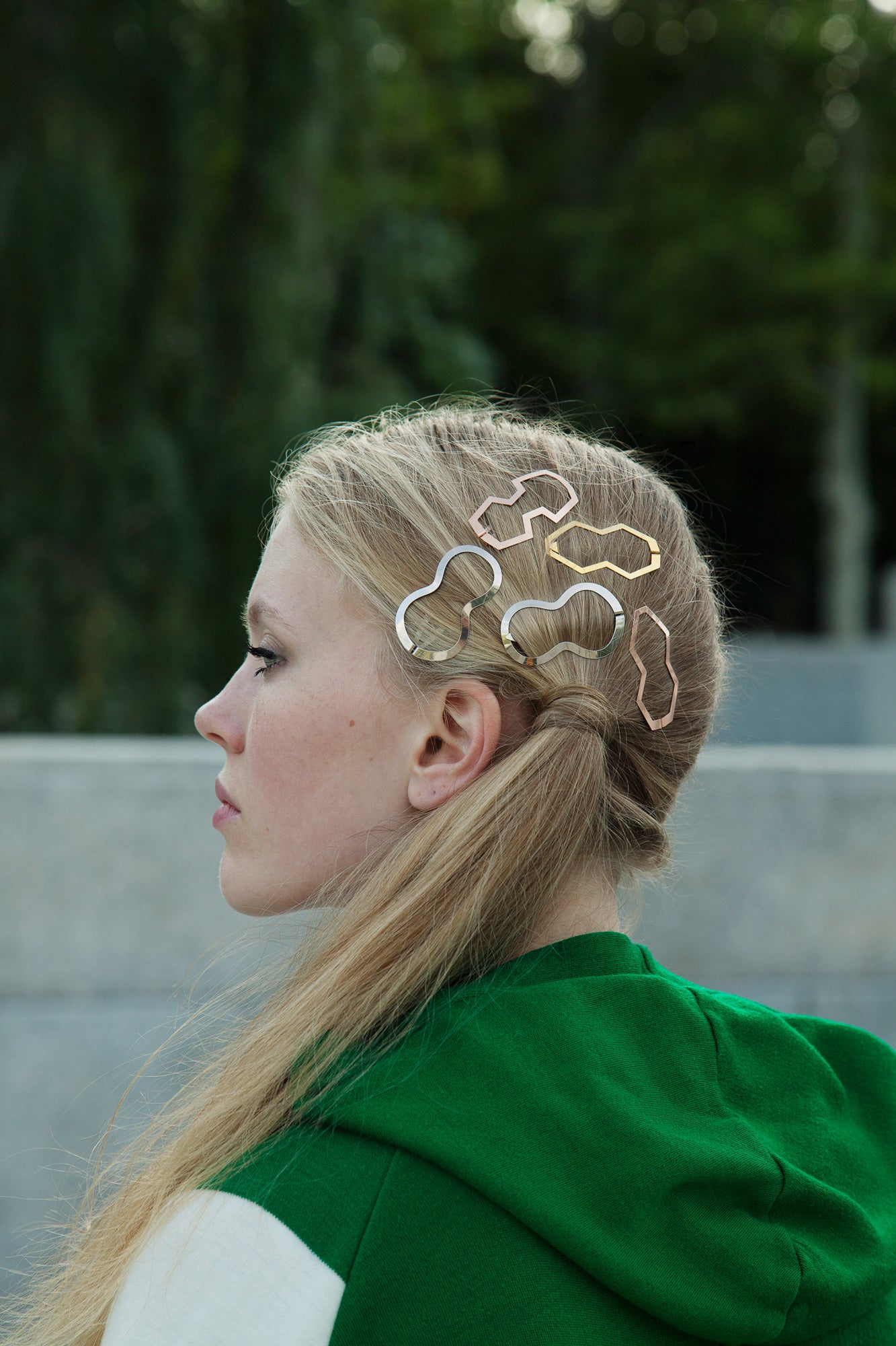 Side view of model wearing a side ponytail adorned with multiple designer hair clips BILLIE, BIA and MARIE by CLINQ 