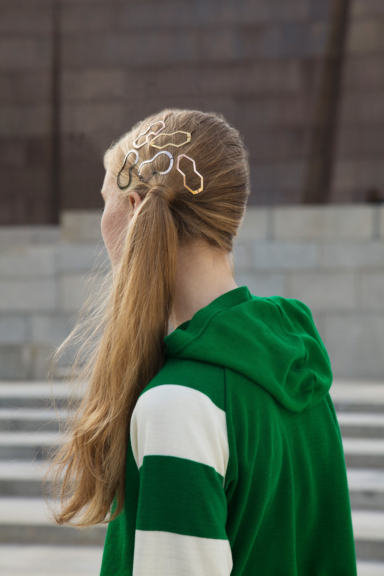 Back view of model wearing a low side ponytail styled with designer hair clips BILLIE, BIA and MARIE by CLINQ 