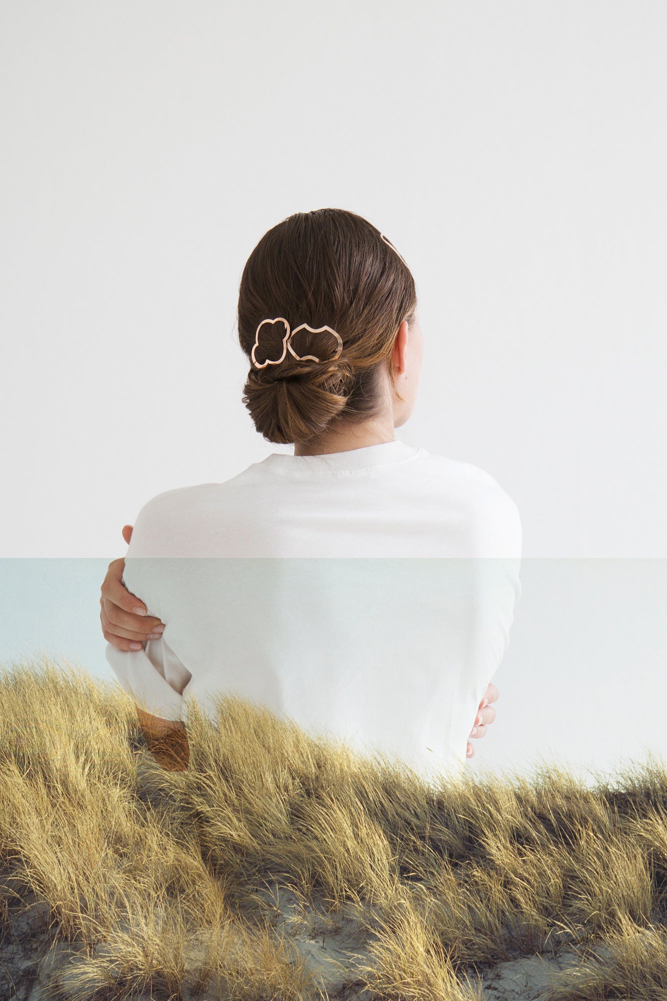 A neat low bun is accented with CLINQ designer hair clips Nona and Alisa. Handmade in Berlin