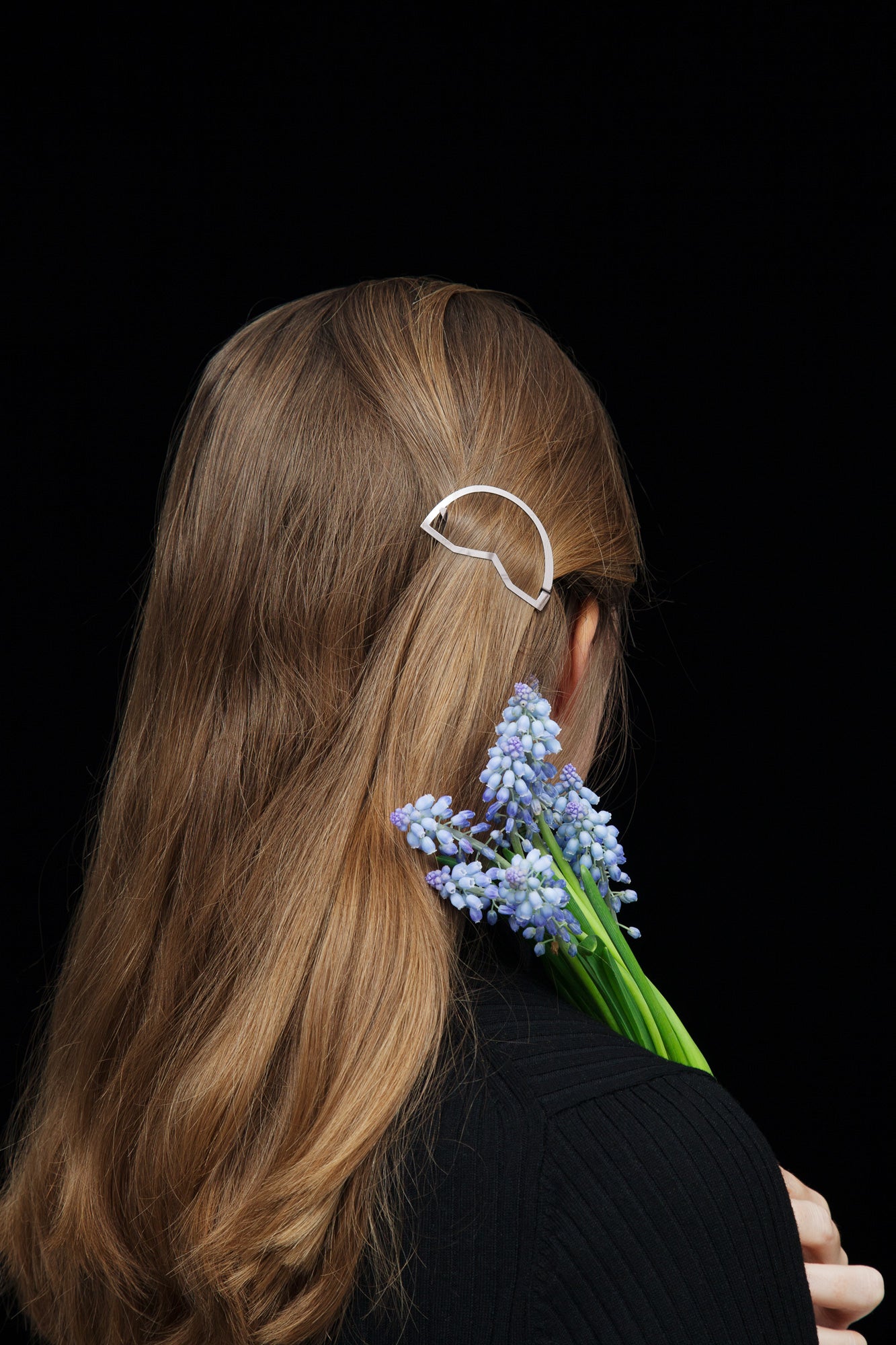 Model wearing her hair down with a strand of hair pulled back with designer hair clip CYNARA by CLINQ